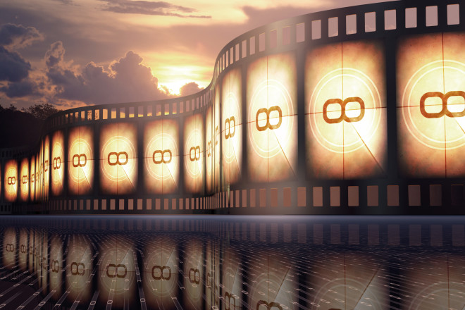 Filmstrip over the reflexive floor with sunset on the background.