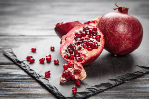 Red juice pomegranate on dark background