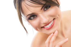 Close-up portrait of young happy smiling brunette woman isolated on white background