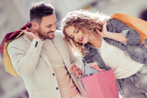 Happy young couple with shopping bags.Sale,consumerism and people concept