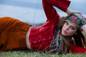 young blonde woman in autumn fashion clothes,  red leather jacket, cashmere scarf and brown skirt outdoor shot