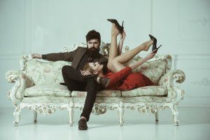 sensual couple on sofa. sensual woman and bearded man relax. sensual girl with her man. sensual and beautiful