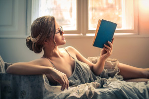 Sensual woman reading in bed
