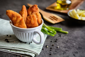 Breaded mini chicken fillets served with potato