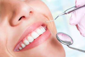 Macro close up of Human teeth with hatchet and mouth mirror