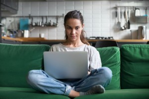 Serious,Woman,Using,Laptop,Checking,Email,News,Online,Sitting,On