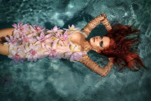portrait of beautiful red-haired girl in the water
