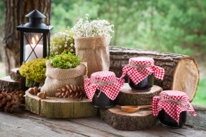 Still life with jars of fruit jam vintage lamp and decoration in rustic style.