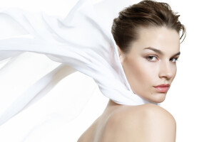 Lightweight beauty visual with a caucasian model wearing a white silk scarf.