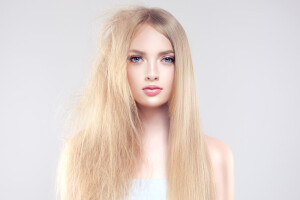 Straightening , smoothing and treatment of the hair . Model girl a half a head straight and smooth hair .The other half of head with tangled unbrushed hair. Care and hair products