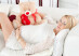 pregnant girl hugging a teddy bear at home